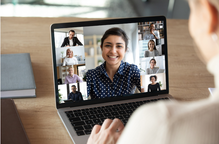 Individual at laptop participating in an online web conference